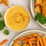 Maple mustard dip in a bowl next to sweet potato fries.