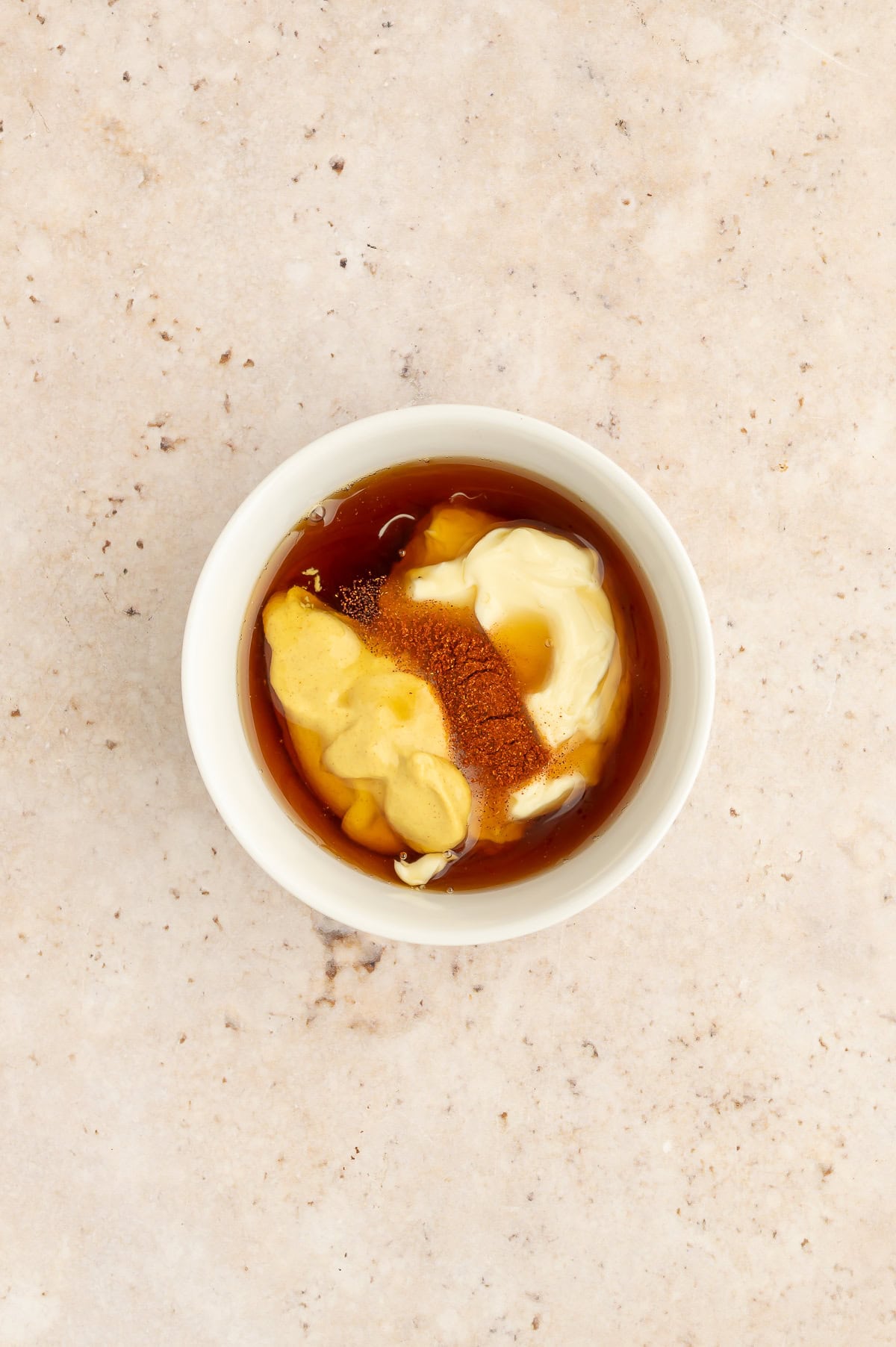 Bowl containing ingredients for maple mustard dip.
