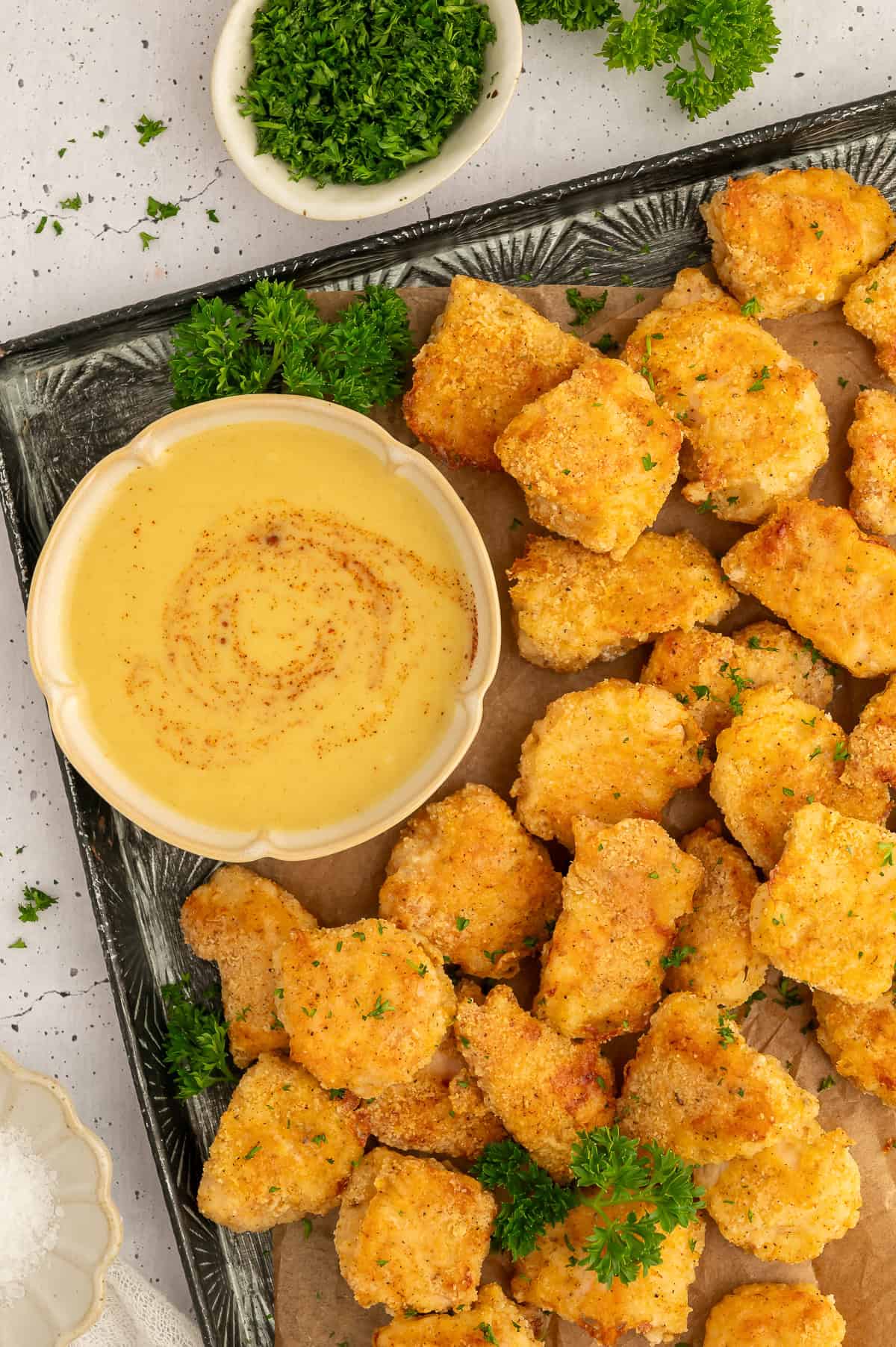 Chicken nuggets on a platter next to maple mustard dip.
