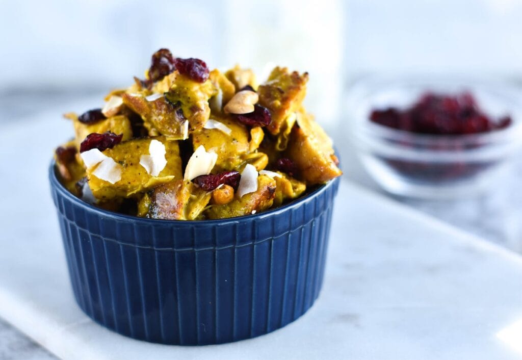 Bowl of chicken salad with curry, cranberries, coconut and cashews