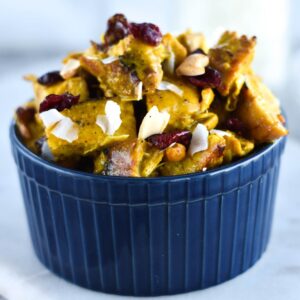 Bowl of chicken salad with curry, cranberries, coconut and cashews