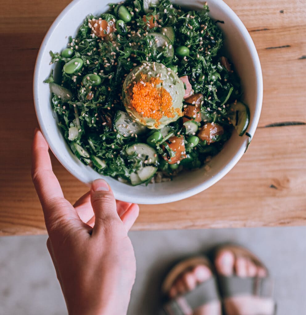 Girl holding bowl of vegetables