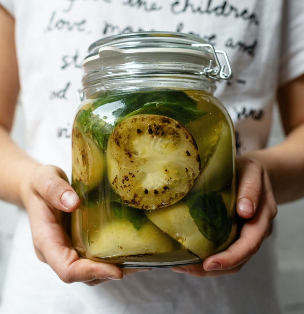 Girl holding jar of fermented vegetables