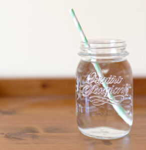 mason jar filled with water and straw
