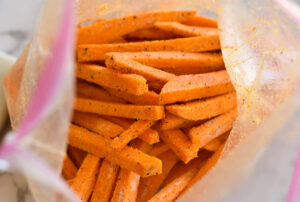 Raw sweet potato fries in a Ziploc bag.