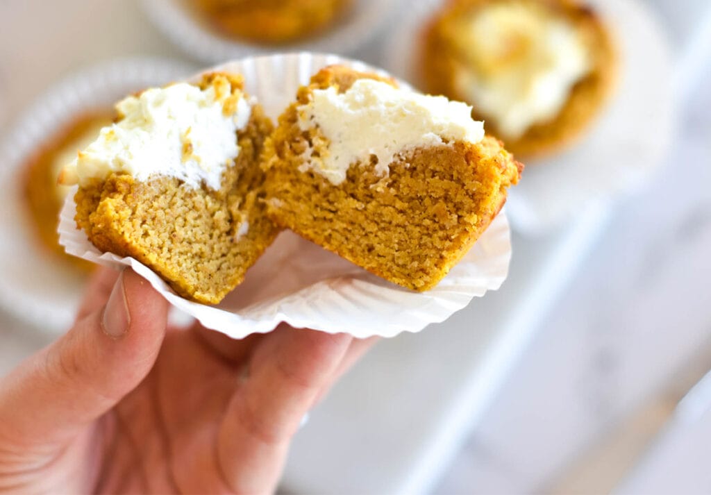 Moist cream cheese filled pumpkin muffin cut in half