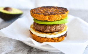 breakfast sandwich made of sweet potato, egg, sausage and avocado