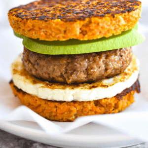 breakfast sandwich made of sweet potato, egg, sausage and avocado