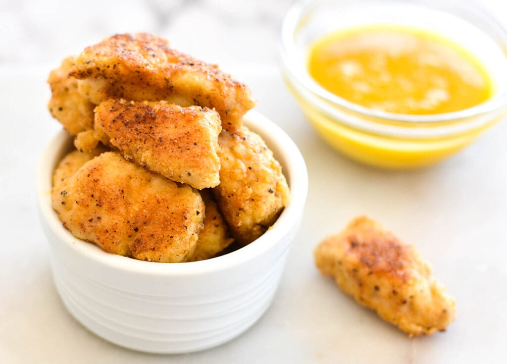 Bowl of chicken nuggets with honey mustard