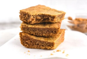 stack of blondie brownies and one has a bite out of it