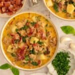 Bowl of dairy-free Zuppa Toscana with chunks of potato, sausage, bacon and kale.