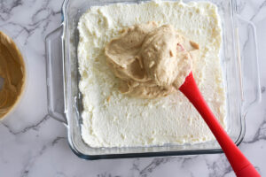 Feta and ricotta whipped together and spread in glass baking dish with dollop of hummus on top.