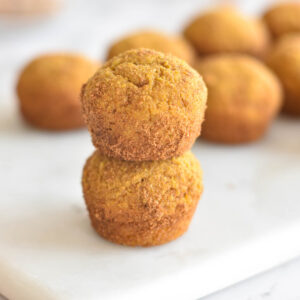 Two stacked donut holes covered in cinnamon coconut sugar.