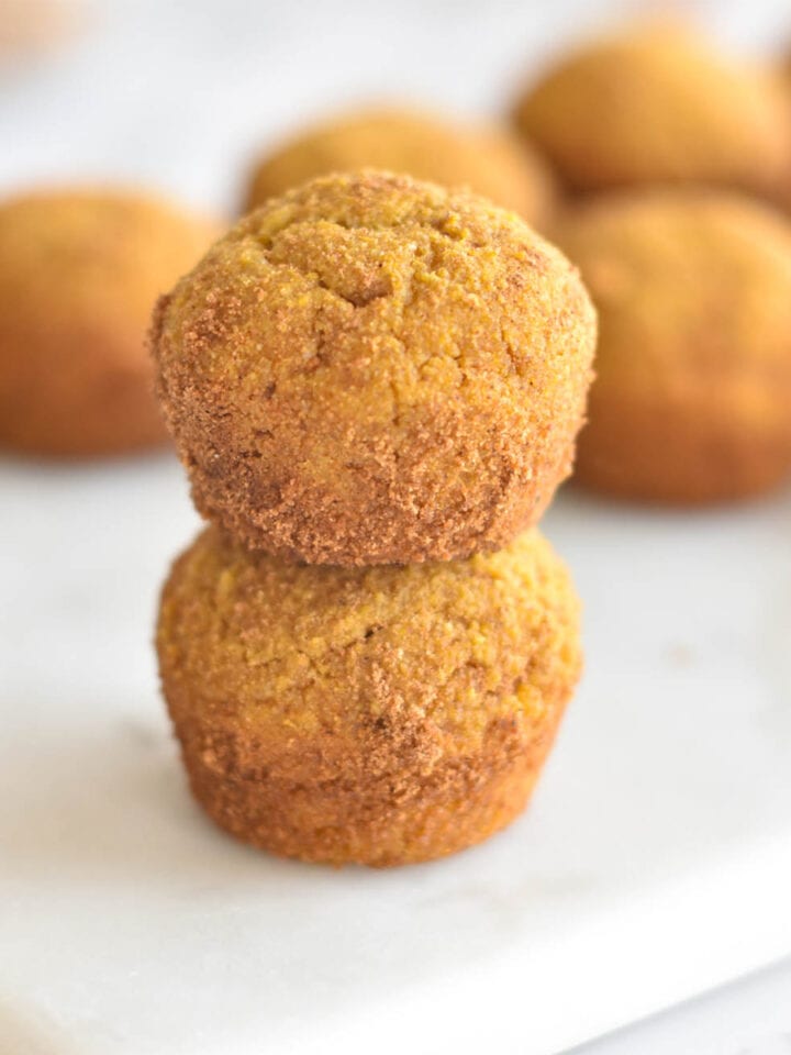 Two stacked donut holes covered in cinnamon coconut sugar.