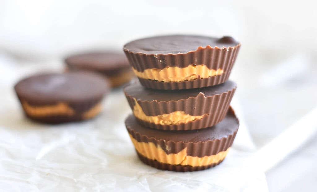 stack of three keto peanut butter and chocolate cups.