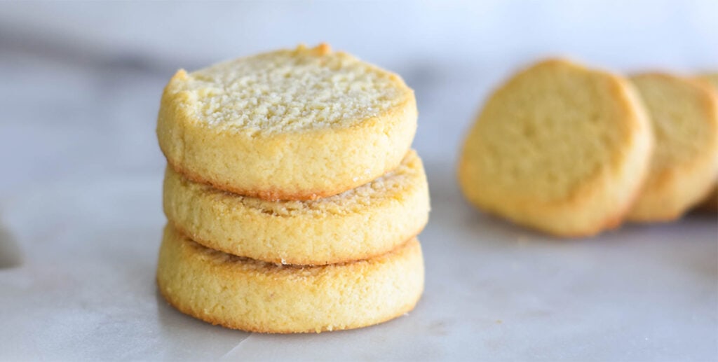 Stack of three golden buttery keto shortbread cookies.