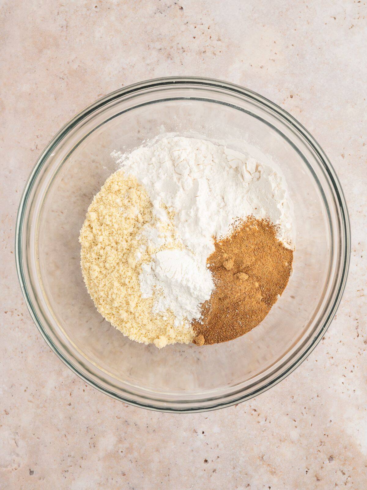 Dry ingredients for paleo waffles in a mixing bowl.