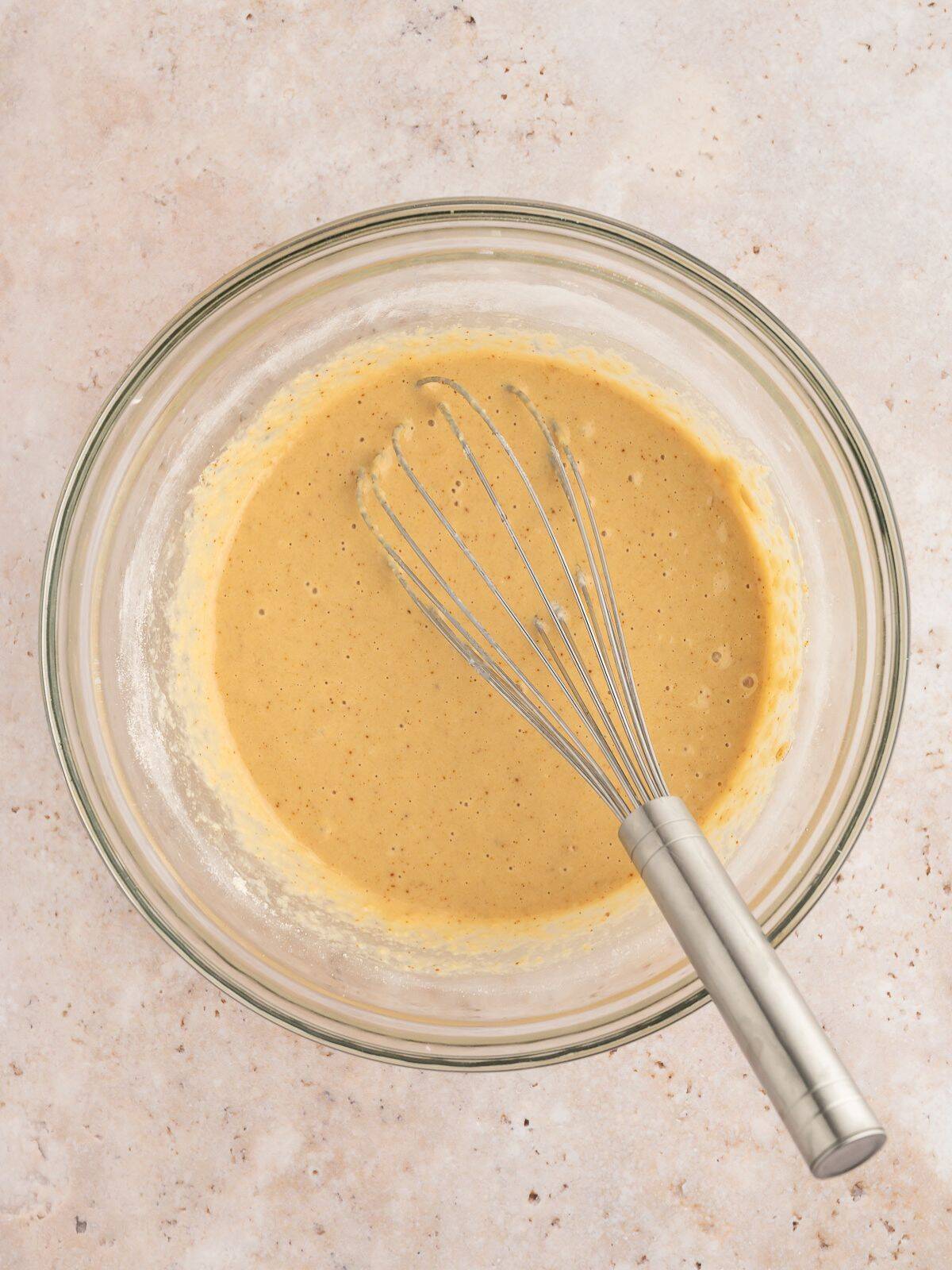 All ingredients for paleo waffles mixed together in a mixing bowl.