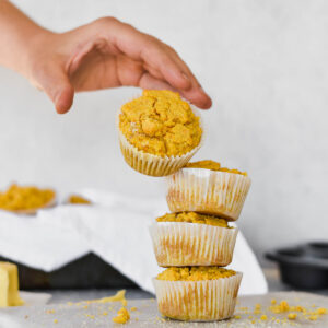 Hand tossing cornbread muffin on to stack.