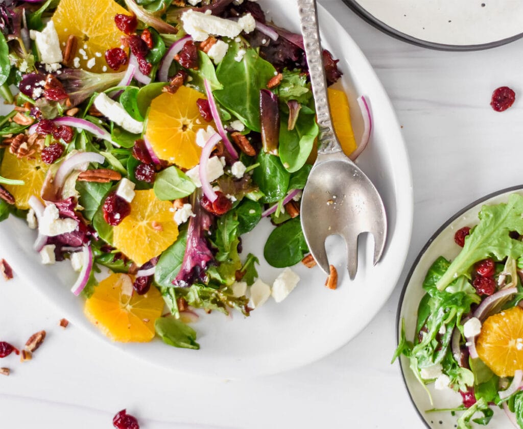 Salad with oranges, cherries, feta, pecans and red onions.