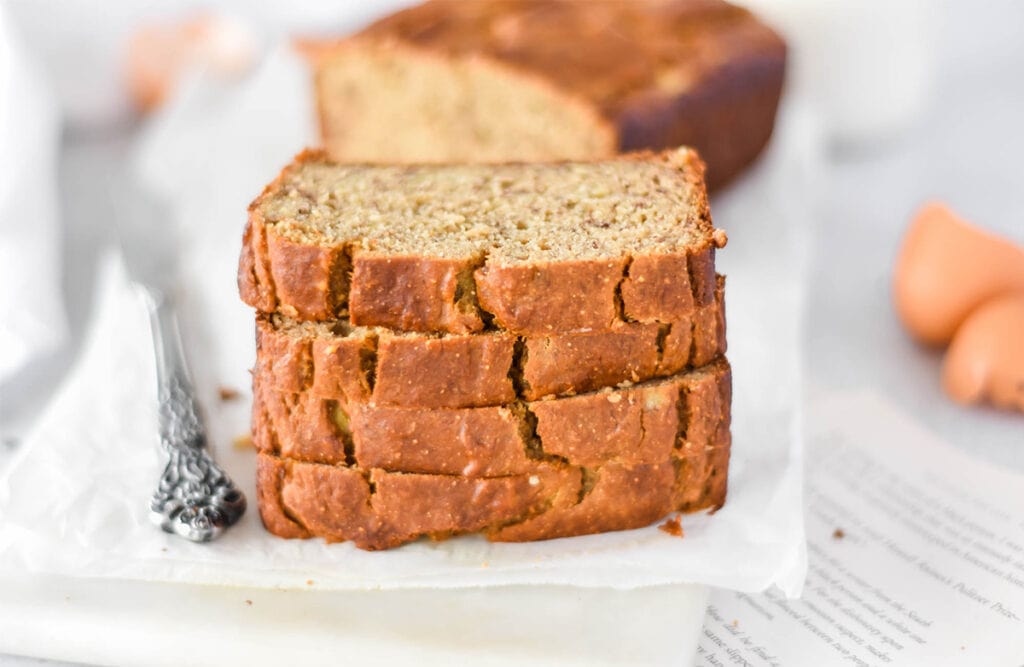 Stack of four slices of chickpea flour banana bread.