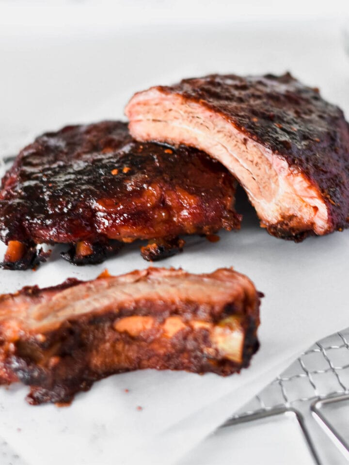 Rack of pellet smoked baby back ribs covered in a sticky looking glaze.