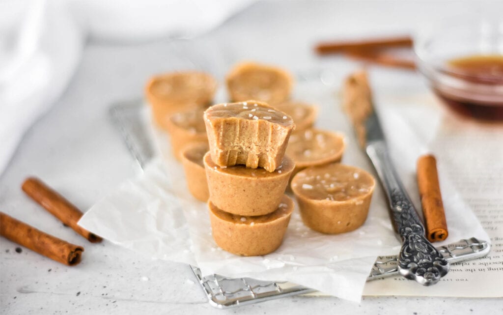 Stack of three paleo maple almond fudge pieces, one with a bite out of it.