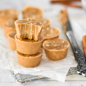 Stack of three paleo maple almond fudge pieces, one with a bite out of it.