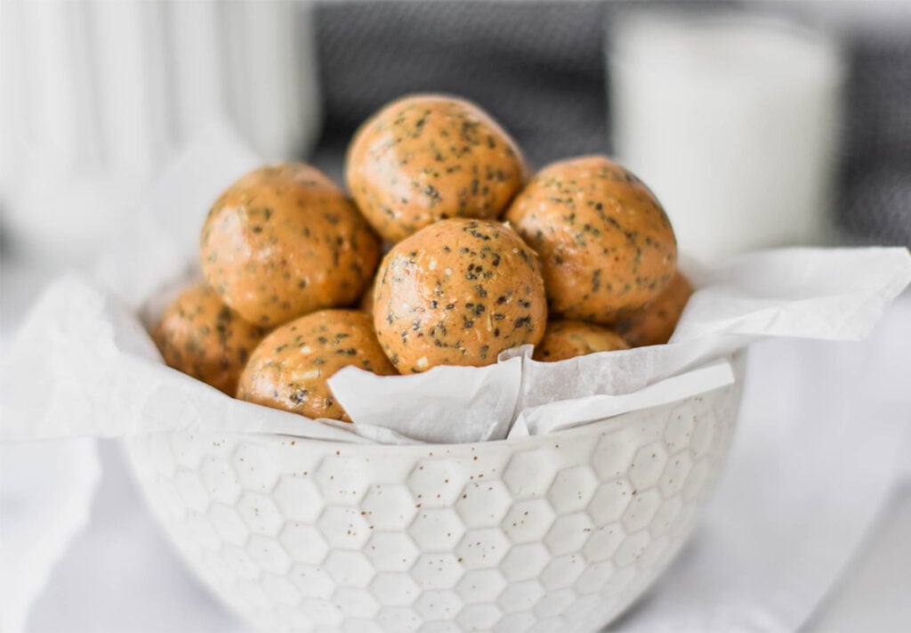 White bowl filled with peanut butter and chia protein balls.