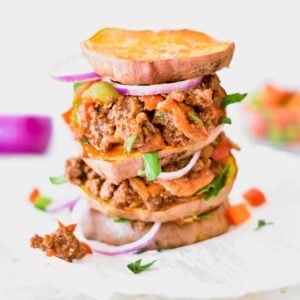 Triple decker Whole30 sloppy joe with red onion and sweet potato rounds instead of buns.