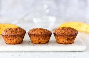 Golden brown paleo banana espresso muffins lined up neatly.