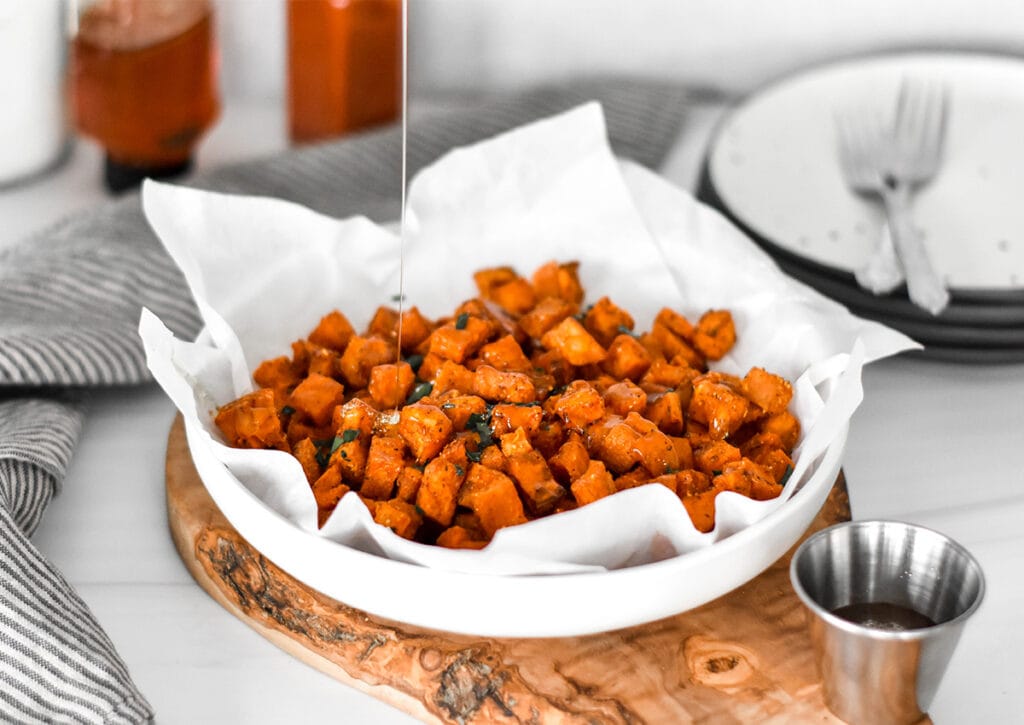 Large plate filled with honey chipotle roasted sweet potatoes.