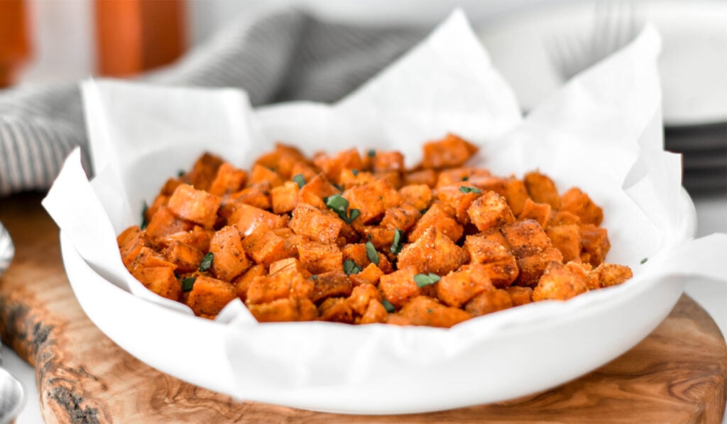 Large plate filled with honey chipotle roasted sweet potatoes.