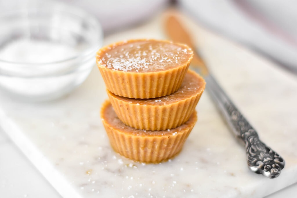 Stack of 3 healthy peanut butter fudge cups .