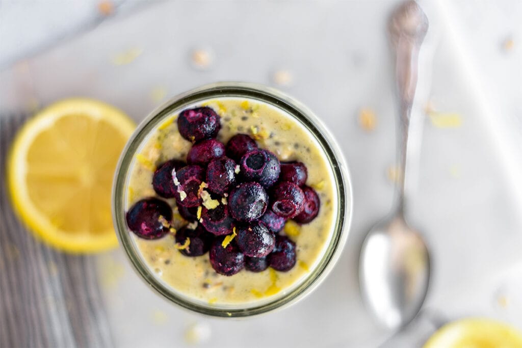 Top down view of mason jar filled with lemon blueberry overnight oats.