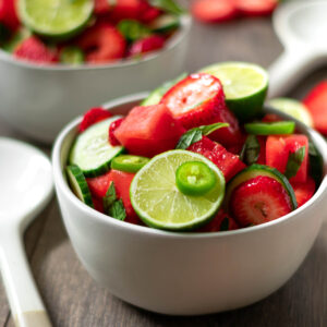 Bowl full of paleo vegan watermelon salad with lime, jalapeño, cucumber and strawberry.