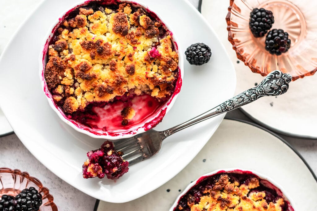 Keto blackberry crumble with brightly colored blackberry filling.