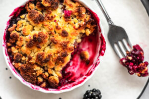 Keto blackberry cobbler with brightly colored blackberry filling.