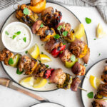 Skewers of Mediterranean chicken kabobs with bell pepper, onion and whipped feta dip.
