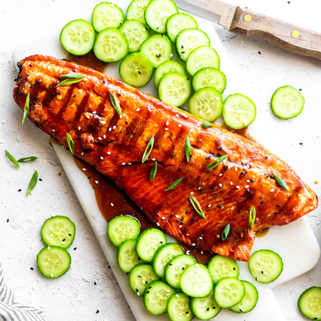 Salmon filet covered with paleo teriyaki sauce, sesame seeds and green onions.