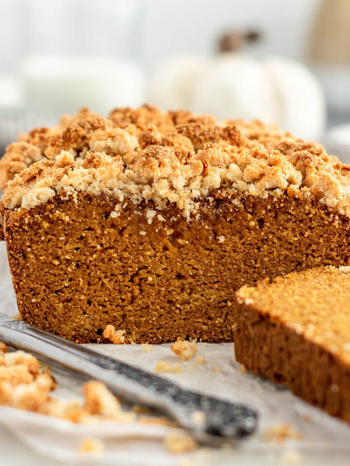 Sliced loaf of Paleo Pumpkin Bread topped with almond flour streusel.