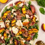 Salad with grilled peaches, burrata, prosciutto, basil, walnuts, shallot and arugula.