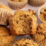 Almond flour banana nut muffin with a large bite out of it.