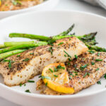 Pan-Seared Halibut coated with seasoning, butter, herbs and lemon.