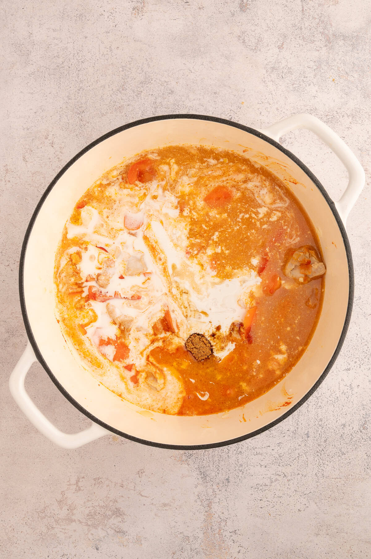 Liquid ingredients and seasonings added to stock pot.