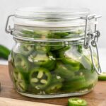Pickled jalapeños in a jar.