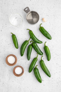 Ingredients for pickled jalapeños: jalapeños, salt, sugar, water, vinegar and garlic.