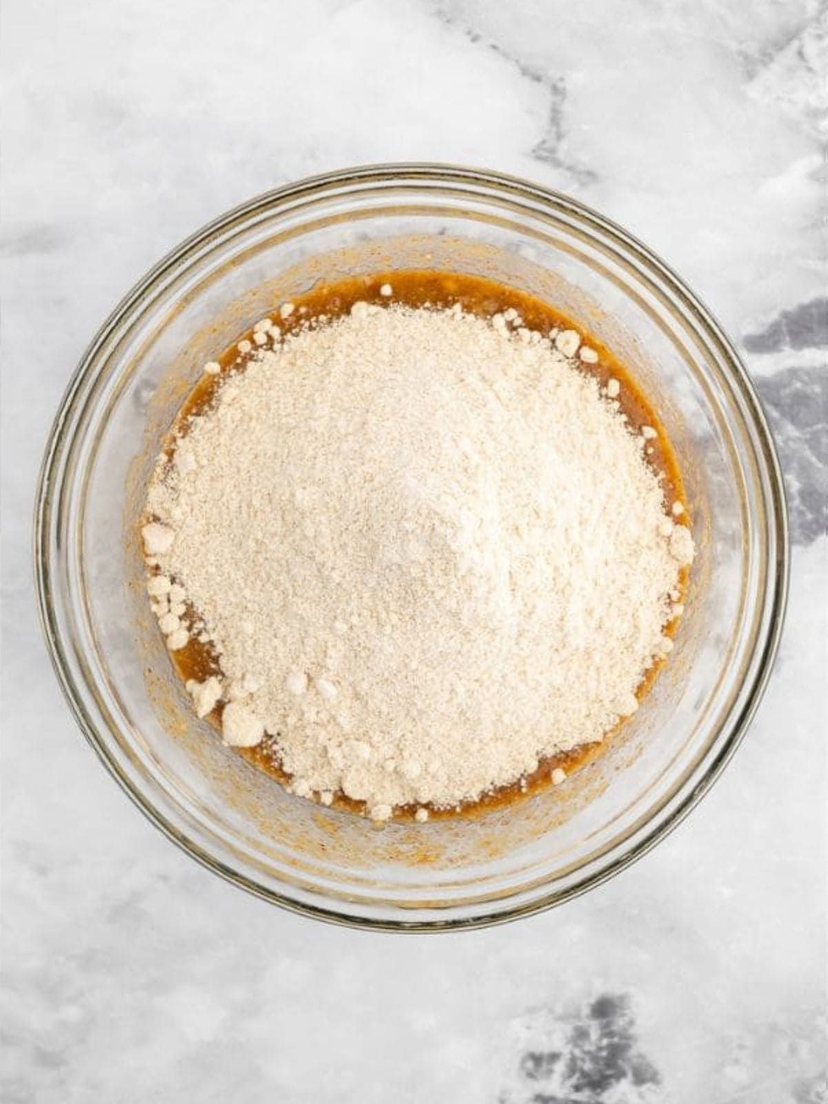 Combining wet and dry ingredients for almond butter banana bread.