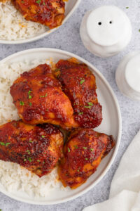 Plate of rice and bright red Honey Harissa Chicken.