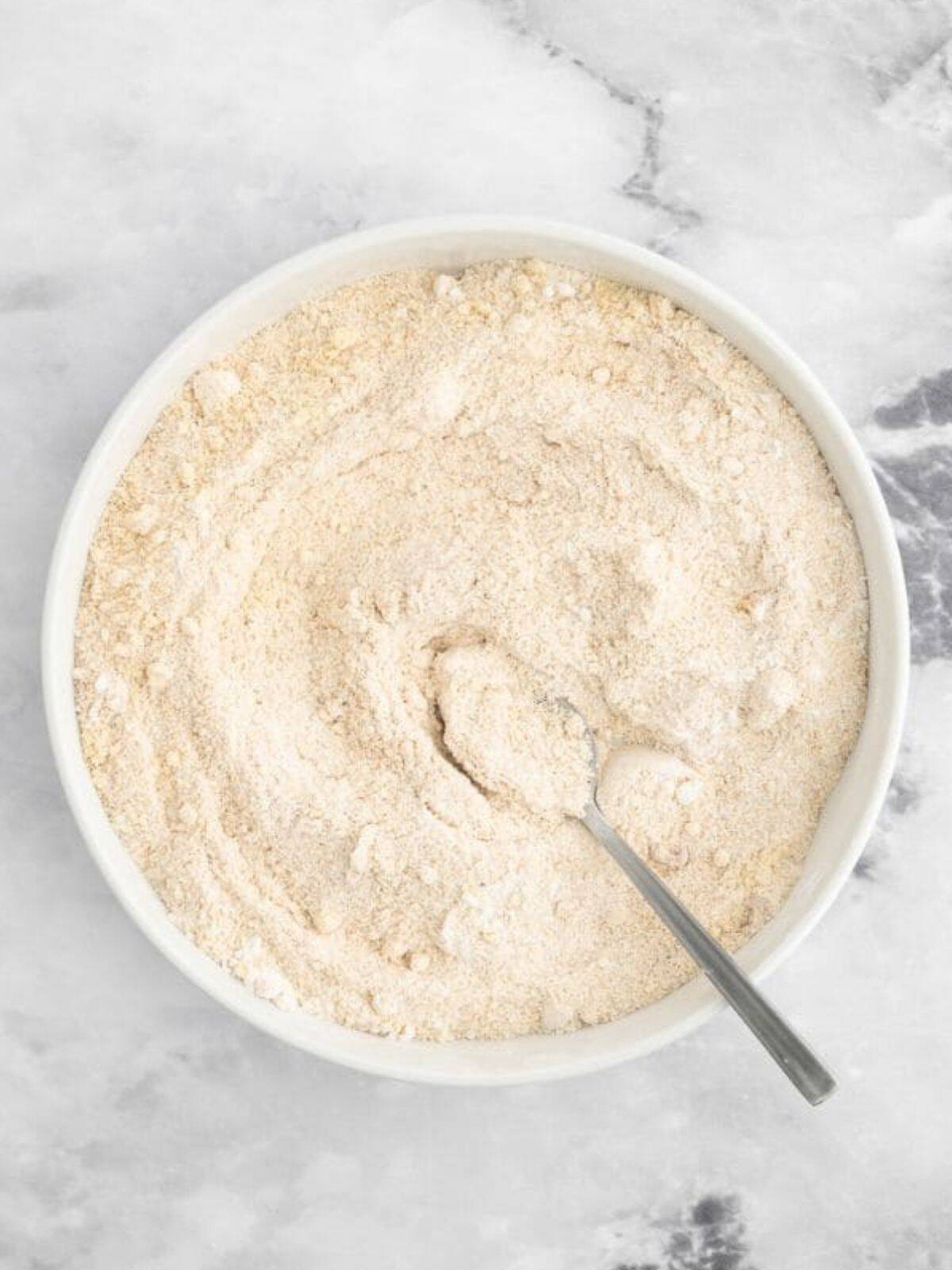 Mixing of dry ingredients for almond butter banana bread.